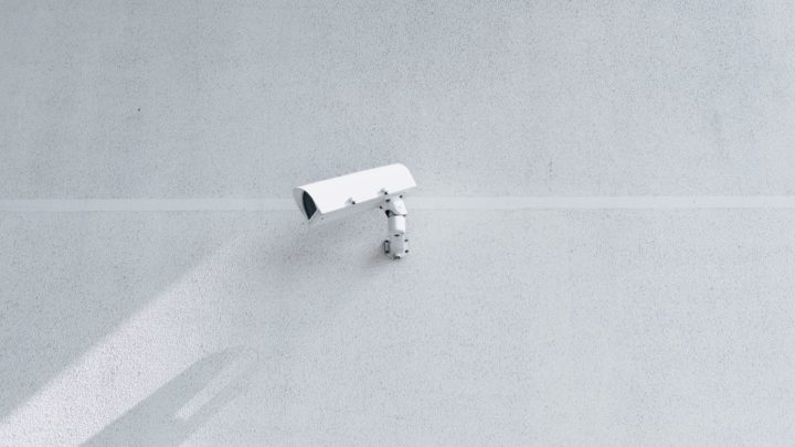Caméra de vidéosurveillance sur le mur d'un grand bâtiment.
